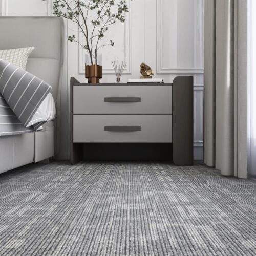 Brown,Wooden,Bedside,Table,By,Gray,Bed,On,Carpet,Floor